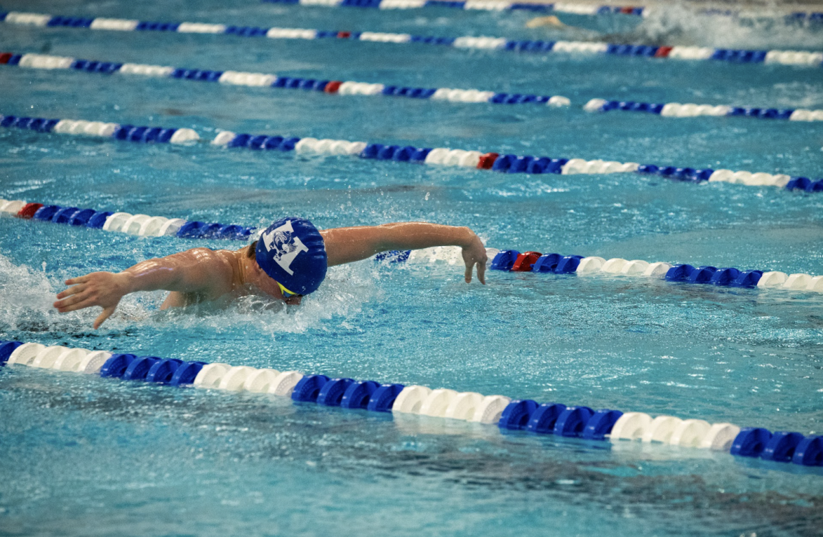 Robbie Koester (11) swims the 100 fly. 